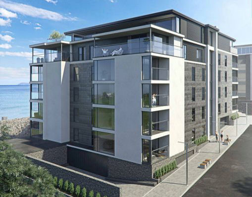 Located on Bath Street Portrush, this modern multi-story apartment building boasts large windows and balconies near the ocean. With a minimalist design, it combines light and dark exterior materials and includes the convenience of an underground carpark.